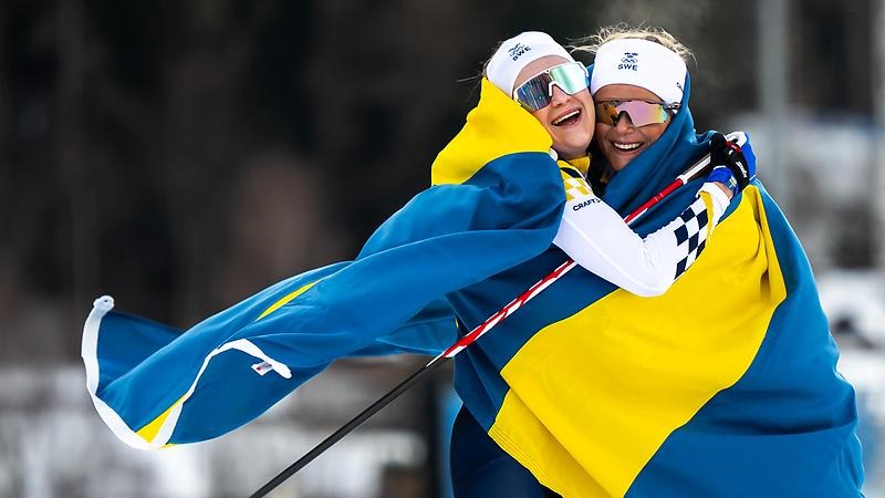 Ebba och Frida insvepta i en svensk flagga